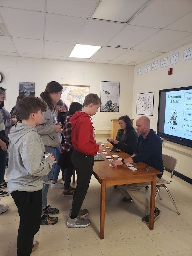 Students buying  and selling stocks form their stock brokers